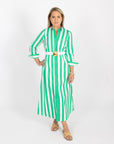 Woman wearing a green and white striped dress on a white background