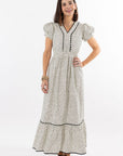 Woman wearing a patterned dress on a white background