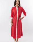 Woman wearing a red dress with white trim on a white background