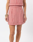 Red and white striped dress worn by a person on a white background