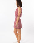 Woman wearing a red and white checkered dress on a white background
