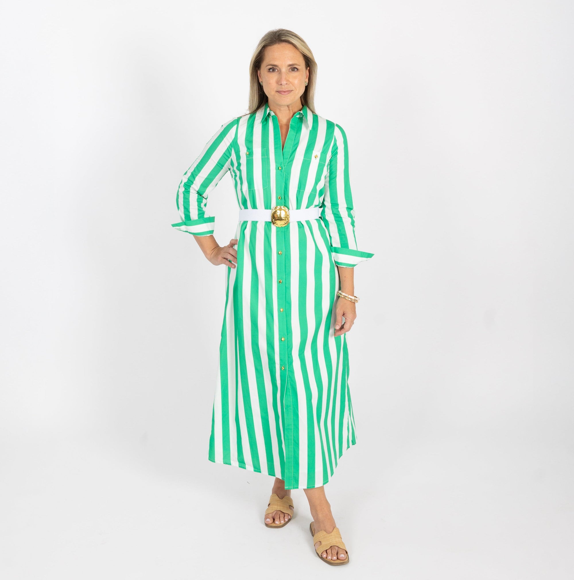Woman wearing a green and white striped dress on a white background