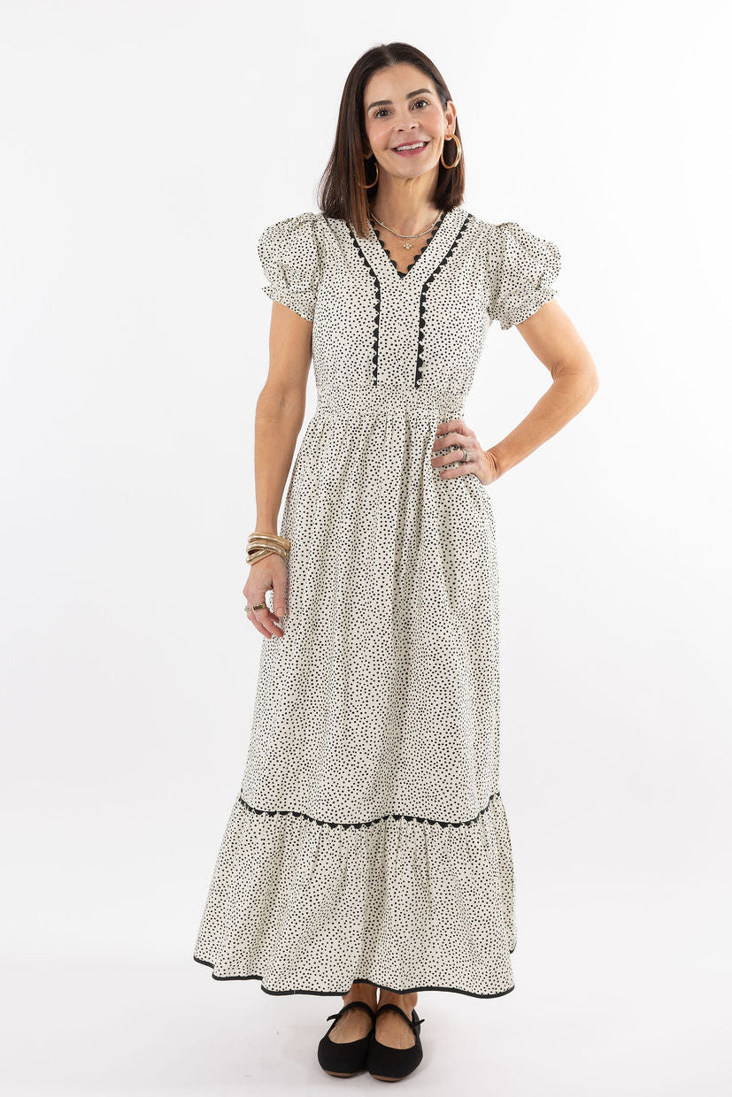 Woman wearing a patterned dress on a white background