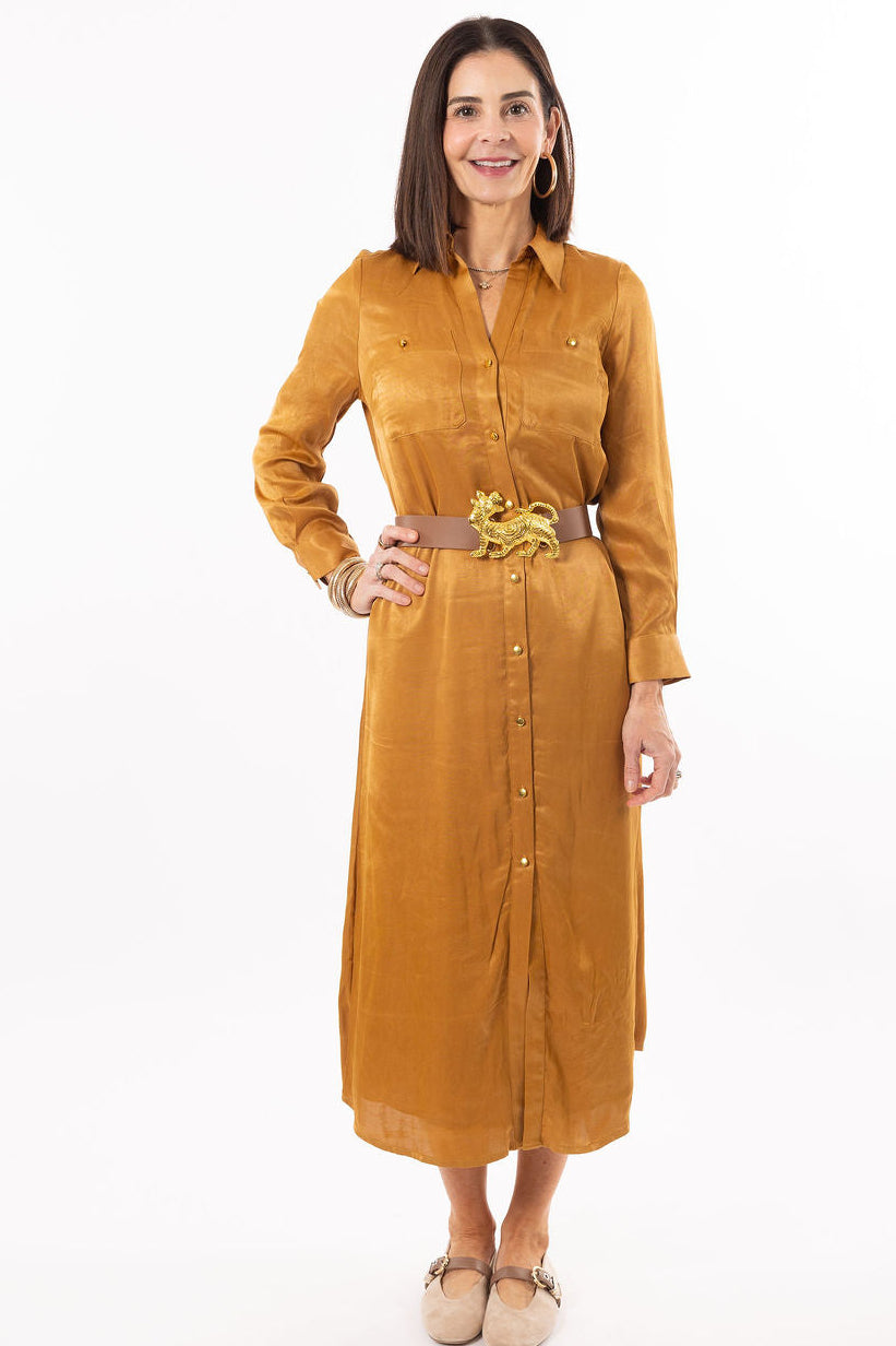 Woman wearing a mustard yellow dress with a belt on a white background