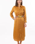 Woman wearing a mustard yellow dress with a belt on a white background