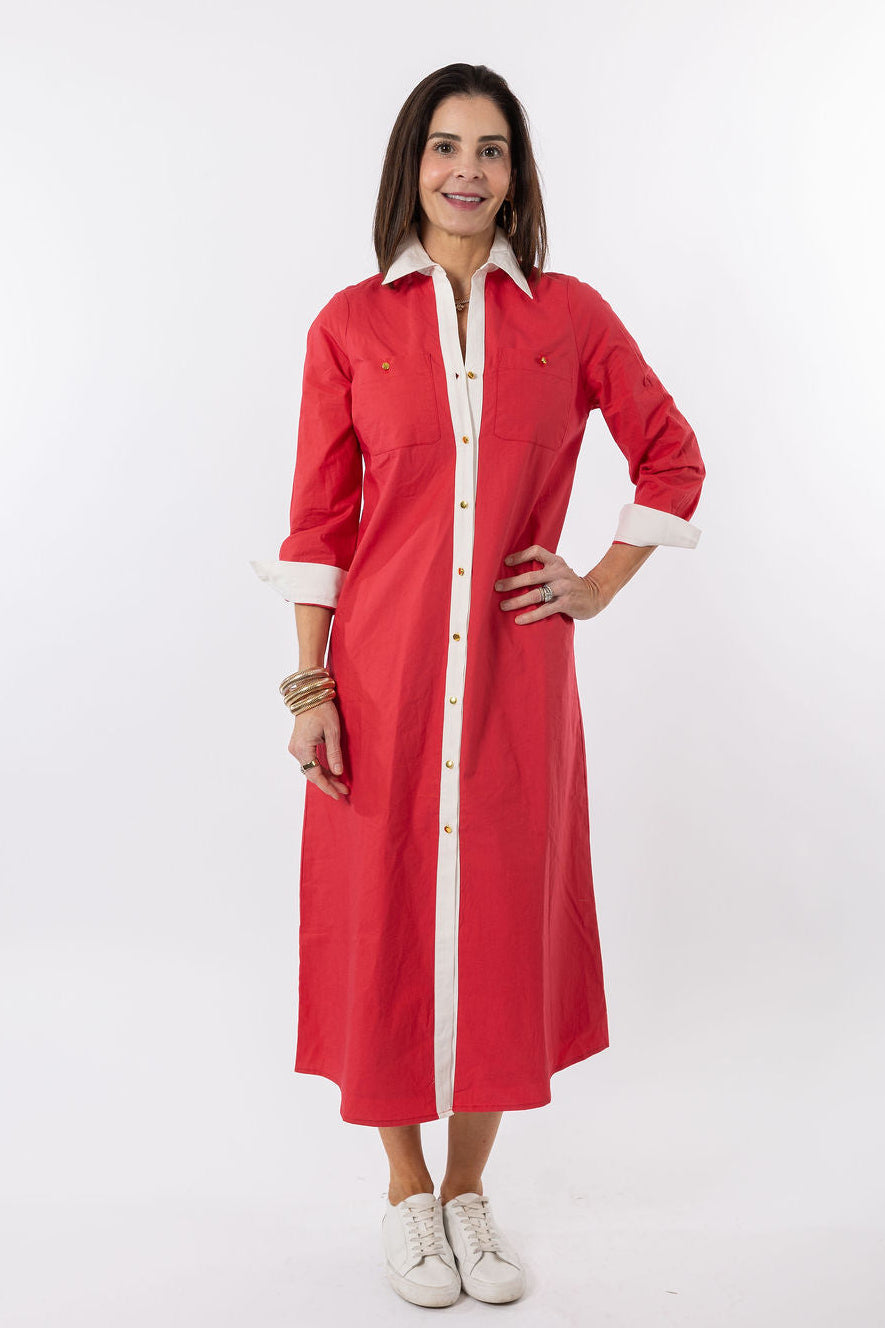 Woman wearing a red dress with white trim on a white background