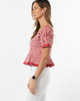 Woman wearing a red and white striped shirt on a white background